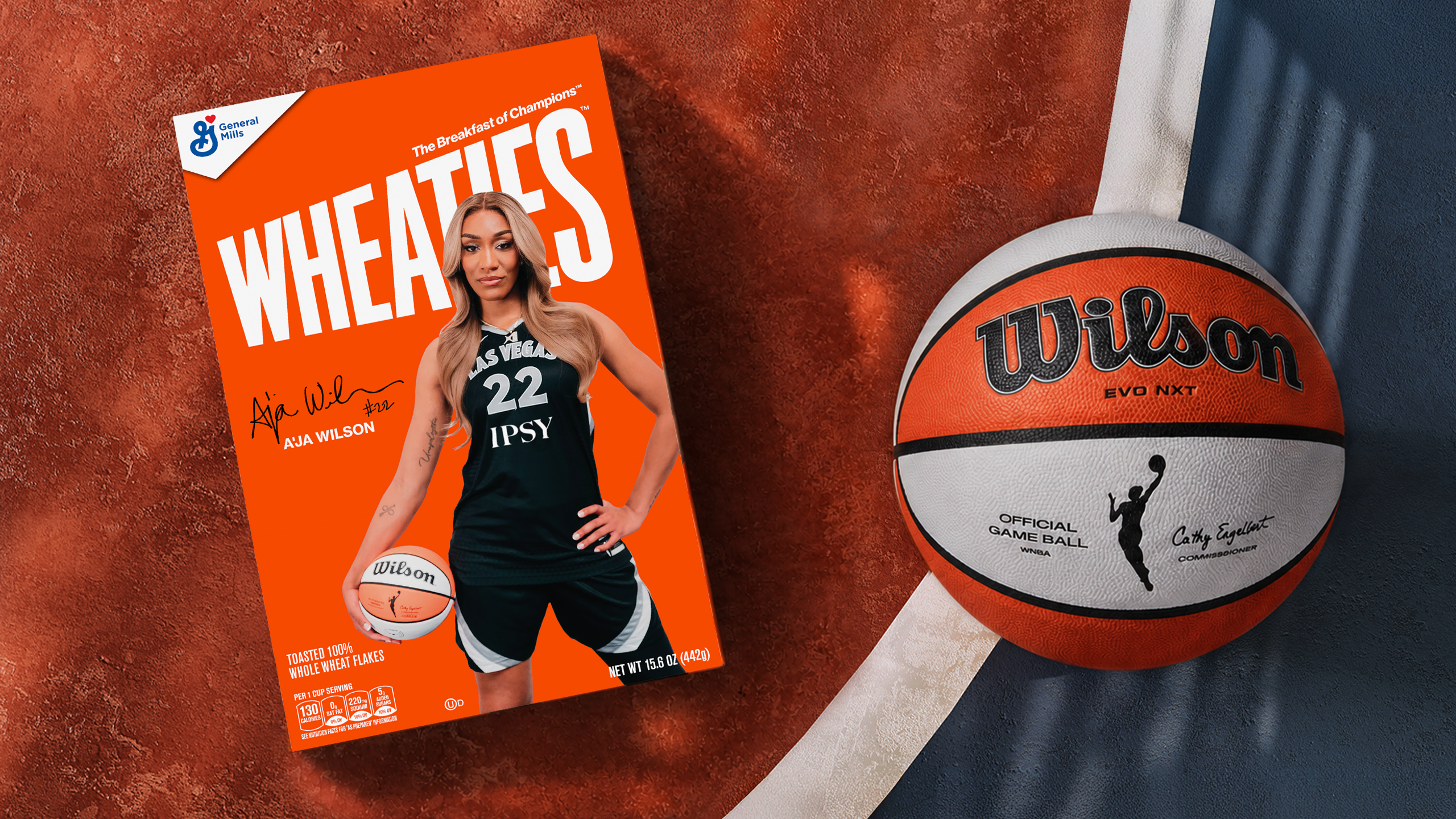 A'ja Wilson posing with a Wheaties box and basketball