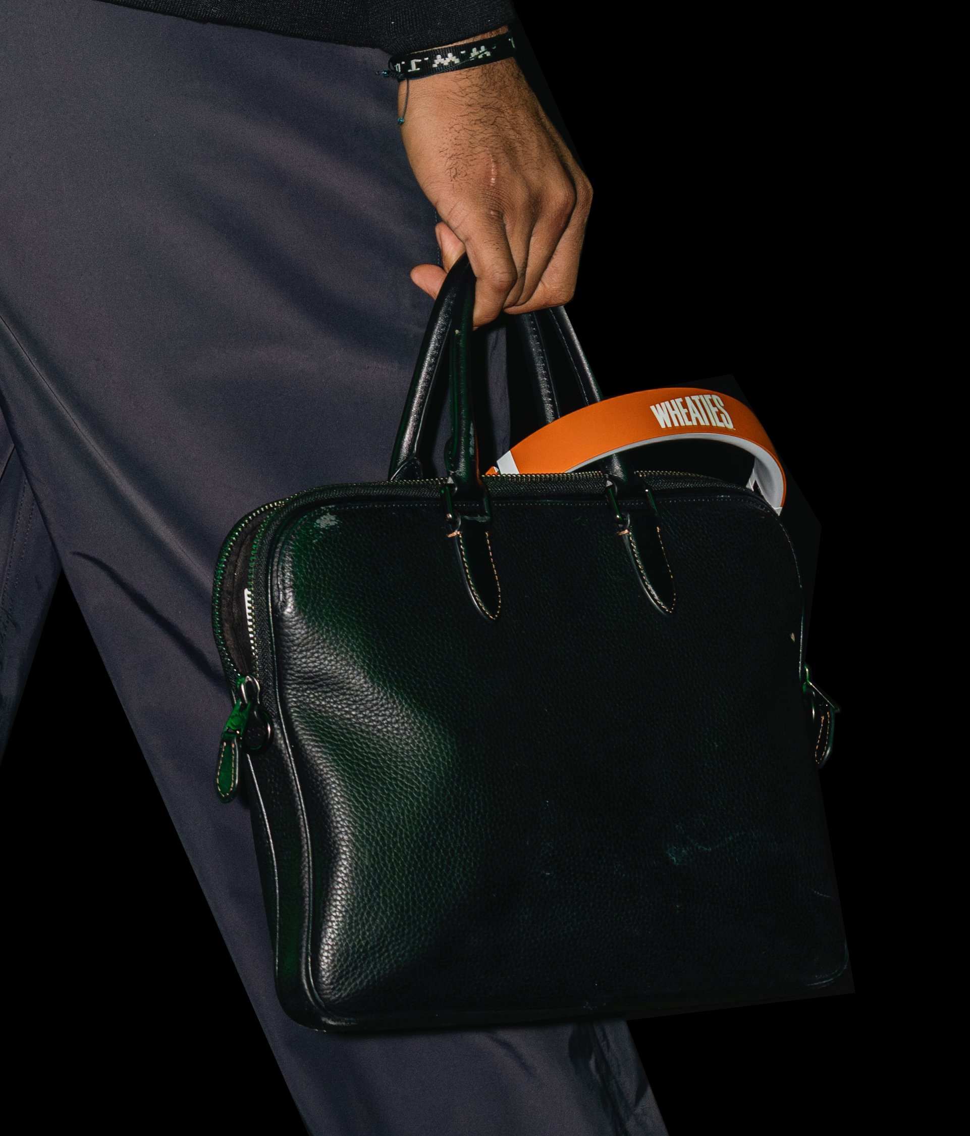Hand holding a briefcase with a Wheaties box inside