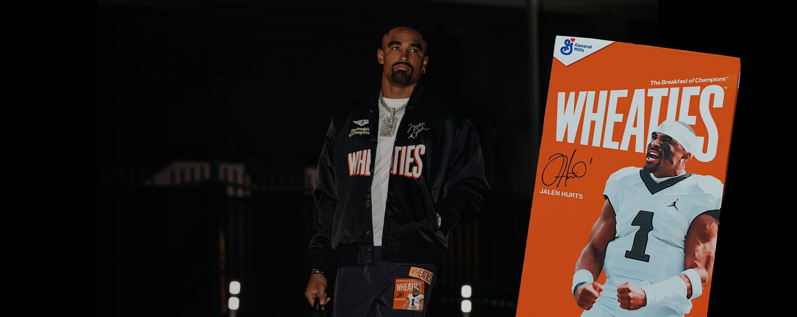 Jalen Hurts standing next to a Wheaties box